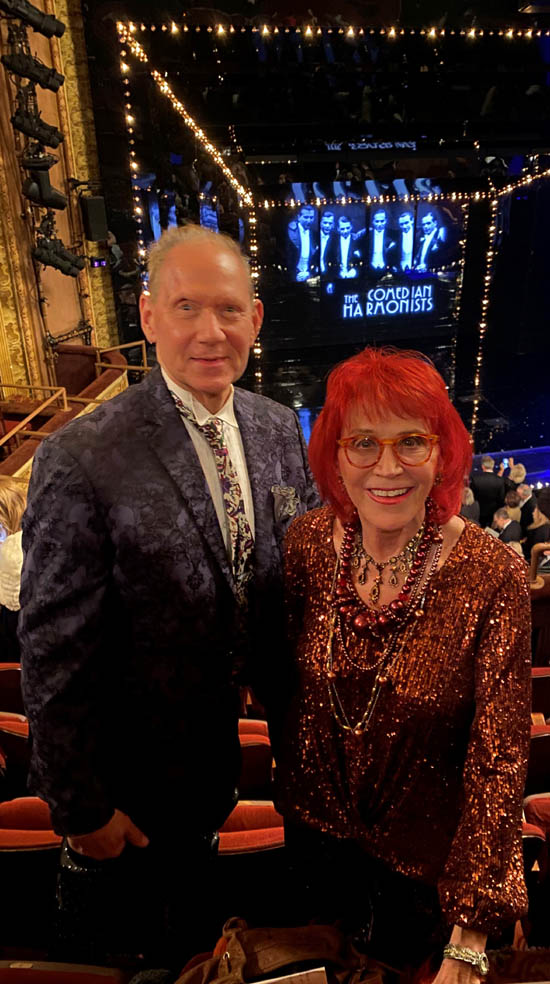 In the theatre on opening night Dr. Judy and Russell Daisey with the stage behind showing the six Comedian Harmonists