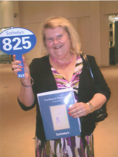 Debbie Tuma with a Sotheby's auction paddle.