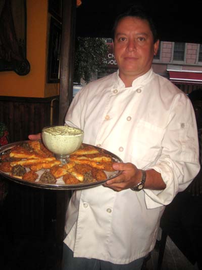 08-14-13 Chef Alonso Tello with a tray of his special hors d'oeuvres, including duck confit, shrimp roll and cheese sticks at a tasting at Trois Canards. 265 West 20th St. Tuesday night 08-13-13