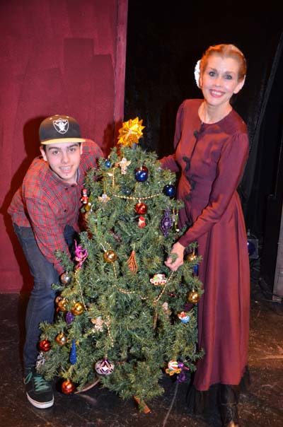 Debbie Dickinson and her son lighting the holidays performance as Mrs. Cratechit in Christmas Carol