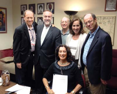 Roy Kardon, president of the Golden Slipper Center for Seniors, Stephen H. Frishberg, president of Golden Slipper Club & Charities, board member Gil Klein, member Barbara Frishberg, and Burt Rose, past president of Golden Slipper Club & Charities with assistant to the president, Celeste Rose (seated)