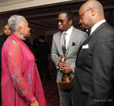 Sharon Robinson honoree Sean Combs and Andre Harrell greet backstage