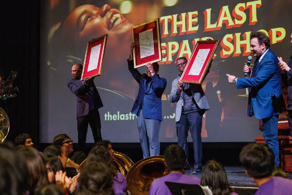 L.A.U.S.D. music educators Vince Womack, Tony White and Erick Quintanilla were honored with framed sheet music from The Last Repair Shop s end credits, signed by multiple generations of L.A.U.S.D. alumni.  Photo by Molly OKeeffe