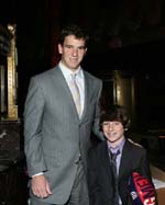 New York Giants quarterback Eli Manning stops to greet a young fan at the "Champions for Children" Gala benefiting coach Tom Coughlin's Jay Fund Foundation which provides financial and emotional assistance to families of children with cancer