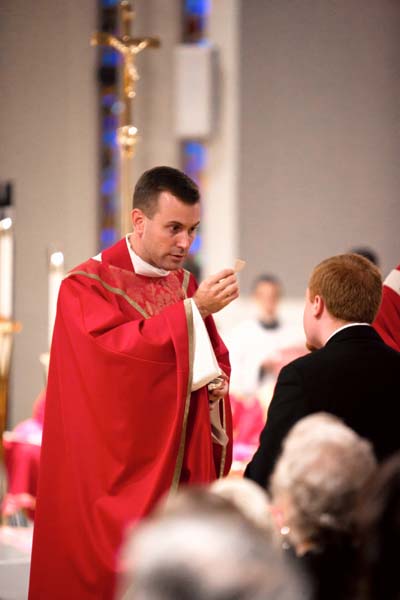 Rector and President, Msgr. David Toups giving communion during his own Rector Installation in September