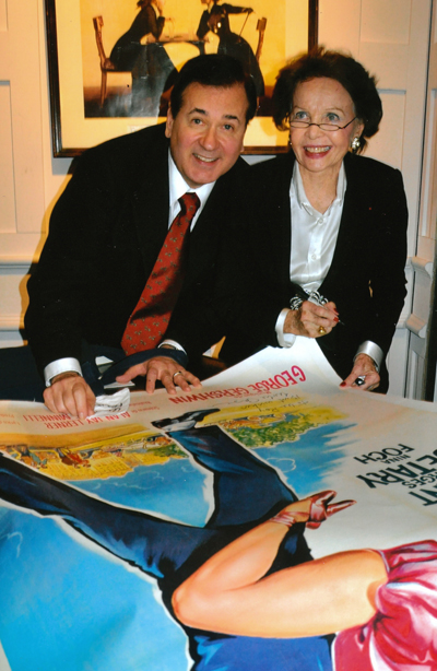 Leslie Caron signing Lee Roy Reams' poster of 