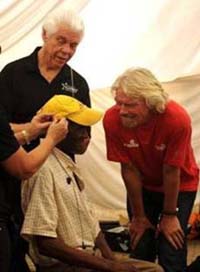  Sir Richard Branson observes as Bill Austin, Founder, Starkey Hearing Foundation, and his team of audiologists fit patients with hearing devices during the Foundations first-ever hearing mission in Bushridge, Mpumalanga, South Africa