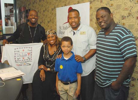 St. Jude patient Emmanuel with Yolanda Adams Morning Show crew during the 5th annual Radio Cares for St . Jude Kids event