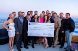 Jenny McCarthy, president of Generation Rescue, stands beside members of the Karma Foundation and other guests who attended the check giving ceremony in Los Angeles. Photo by Nick Alumbaugh