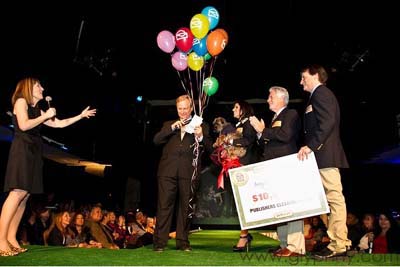 David Frei (center) is surprised and grateful for Publishers Clearing House (PCH) and their famous Prize Patrol presenting a $10,000 check for Angel on a Leash