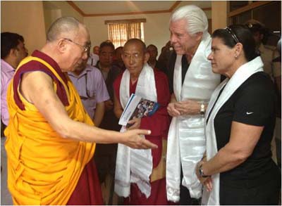 The Dalia Lama blesses Bill and Tani Austin, founders of Starkey Hearing Foundation, as Lama Guru Gyaltsen looks on