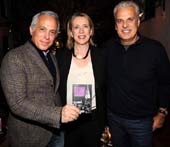 Chef Geoffrey Zakarian, Jilly Stephens (Executive Director of City Harvest) and Chef Eric Ripert pose with City Harvest's 2014 Restaurant Guide, which highlights New York's most generous restaurants. Photo by Bryan Bedder/Getty Images for City Harvest