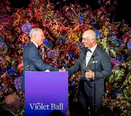 Mark Bezos accepts a rocket-themed award from NYU Langone Dean and CEO Robert I. Grossman, M. Photo by: David DuPuyD