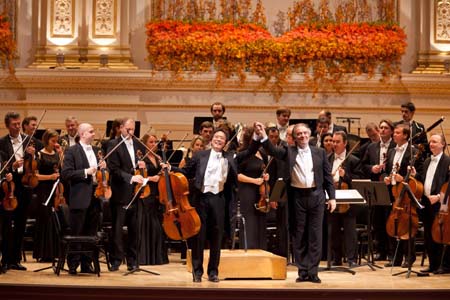 Cellist Yo-Yo Ma and Maestro Valery Gergiev take a bow in front of the Mariinsky Orchestra after their performance